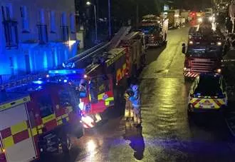 Block of flats evacuated after fire leaves woman injured