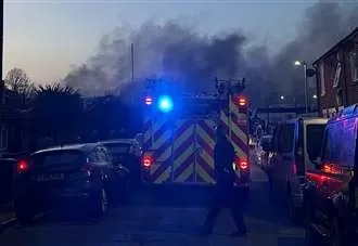 Smoke billows from business as fire crews descend on blaze